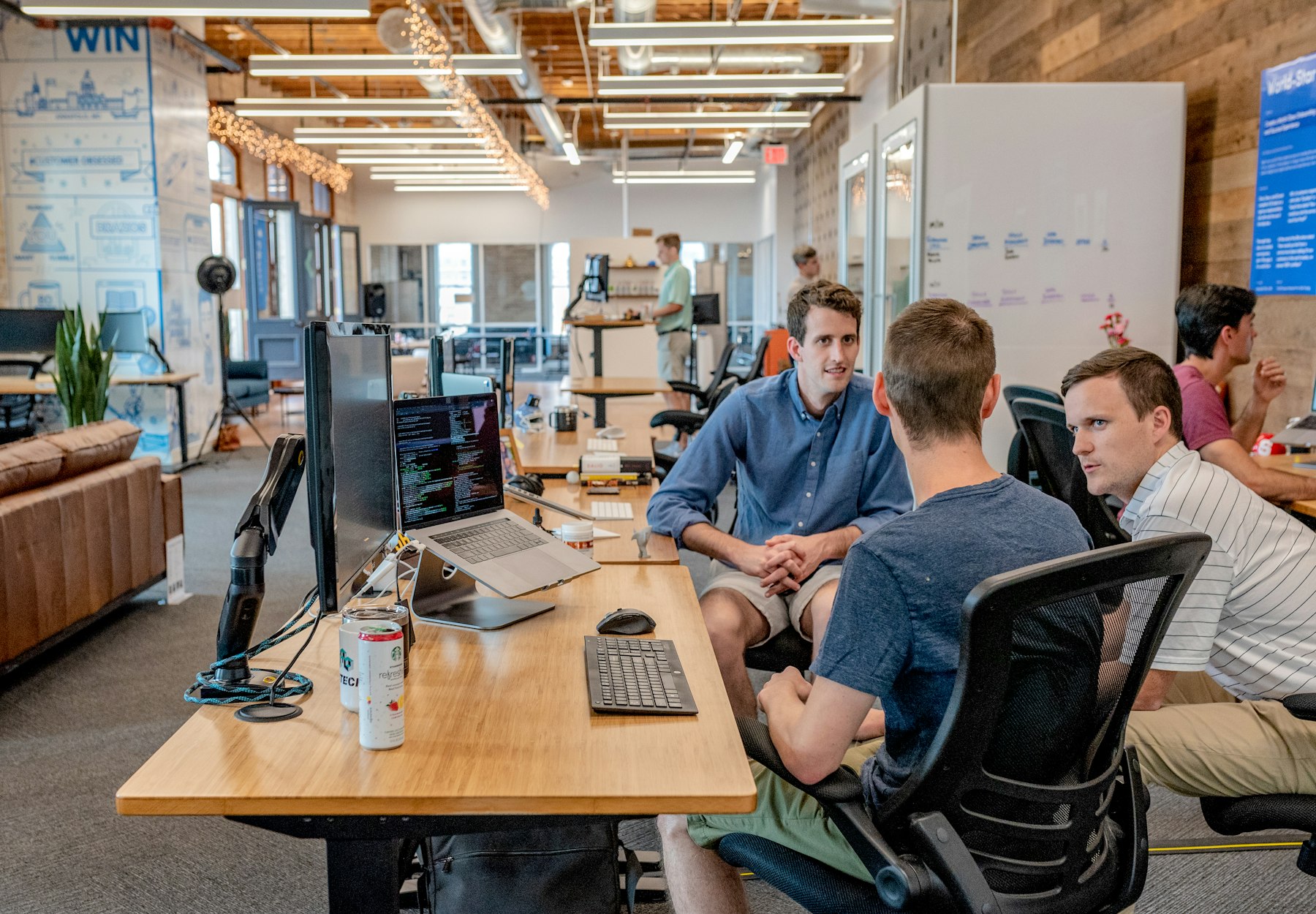 Engineering team working across screens in a modern technology office